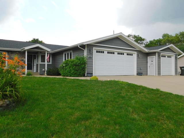 single story home featuring a garage and a front lawn