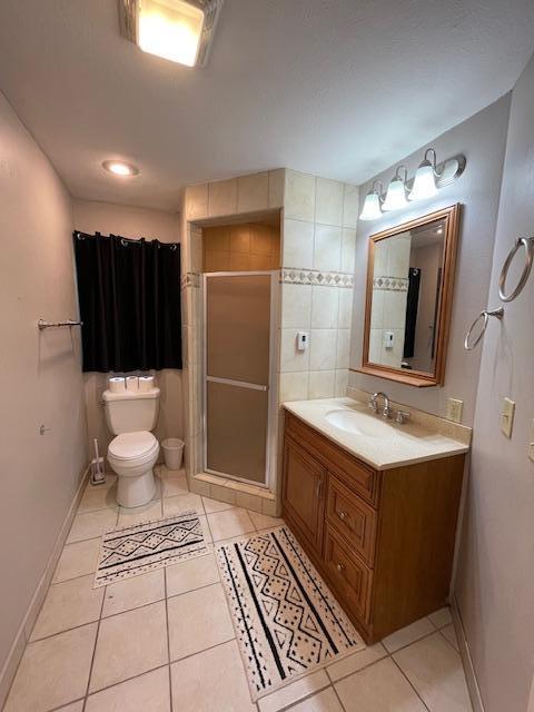 675 10th St, Granite Falls, MN 56241 - bathroom with vanity, tile patterned flooring, and a shower stall