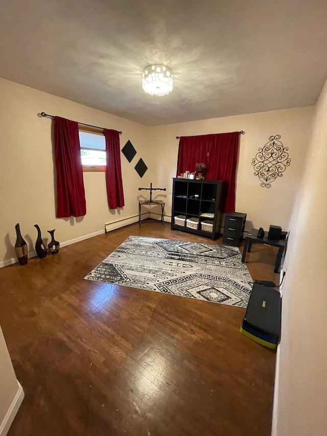 675 10th St, Granite Falls, MN 56241 - living area featuring wood finished floors and a baseboard heating unit