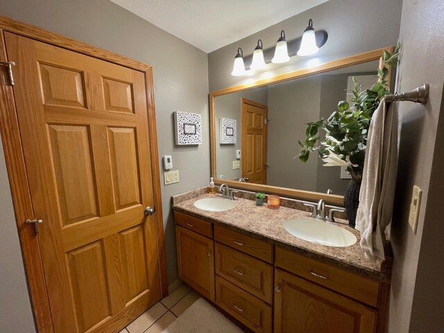 675 10th St, Granite Falls, MN 56241 - full bathroom with double vanity and tile patterned flooring