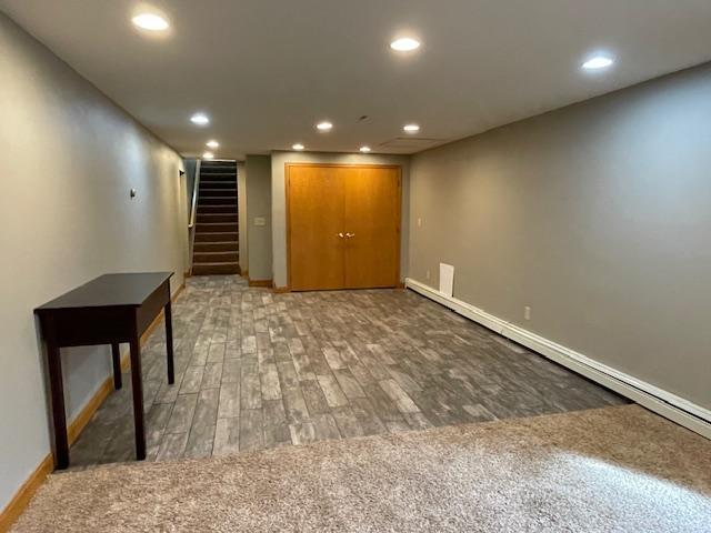 675 10th St, Granite Falls, MN 56241 - finished basement featuring recessed lighting, stairway, wood finished floors, and baseboard heating