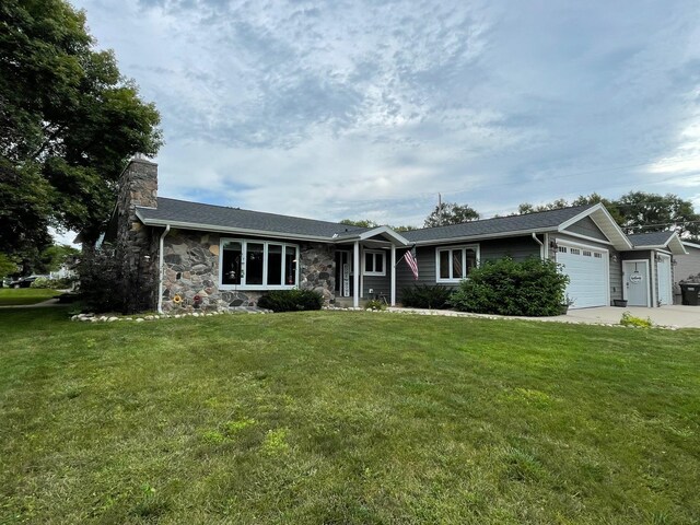 675 10th St, Granite Falls, MN 56241 - single story home with a garage, a chimney, a front yard, stone siding, and concrete driveway