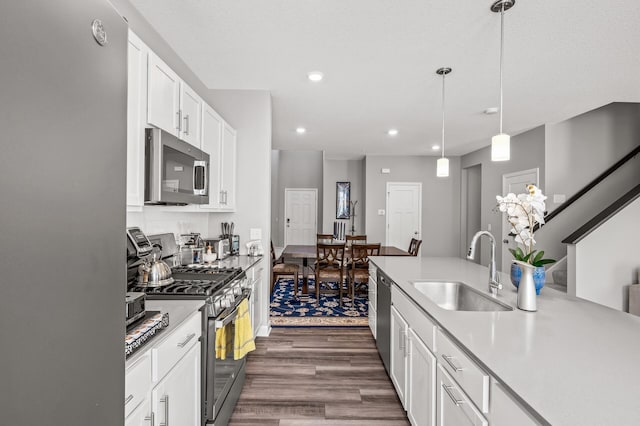 10896 Territorial Trl, Dayton, MN 55369 - kitchen featuring appliances with stainless steel finishes, a sink, light countertops, dark wood finished floors, and recessed lighting