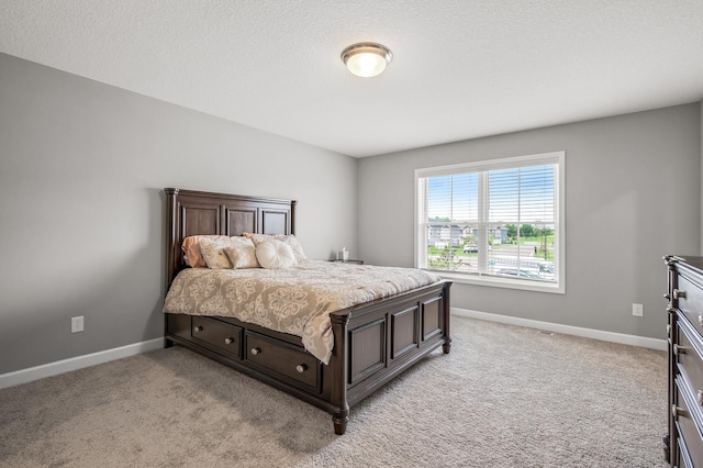 carpeted bedroom featuring a textured ceiling