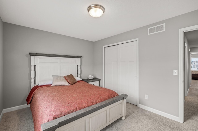 bedroom with light carpet and a closet