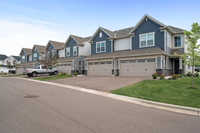 10896 Territorial Trl, Dayton, MN 55369 - townhome / multi-family property featuring driveway, a residential view, a garage, a front lawn, and stone siding