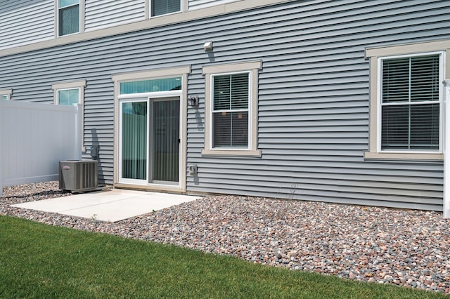 10896 Territorial Trl, Dayton, MN 55369 - doorway to property with central AC, fence, and a patio area