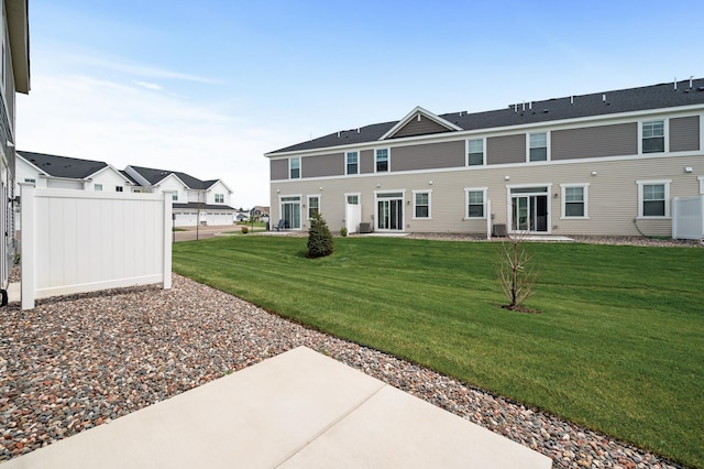 rear view of house featuring a patio and a lawn