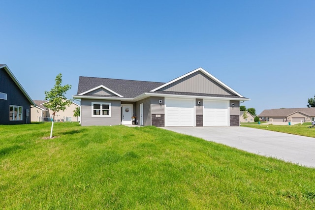 view of front of home with stone siding, a front yard, an attached garage, and driveway