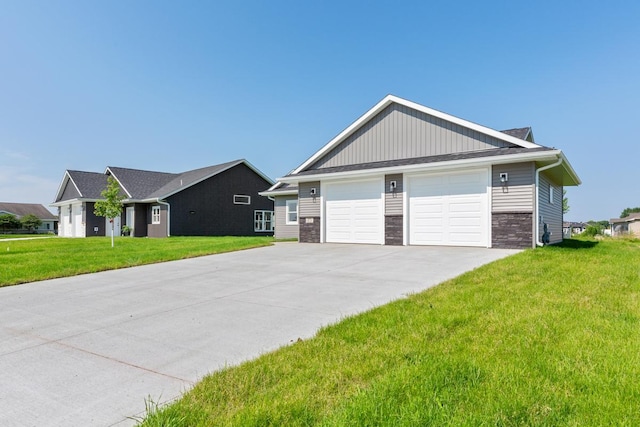 view of front of property featuring a front yard, a garage, and stone siding