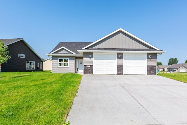 view of front of property with a front lawn, a garage, stone siding, and concrete driveway