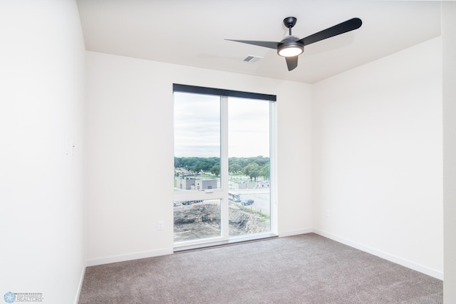 carpeted empty room featuring ceiling fan