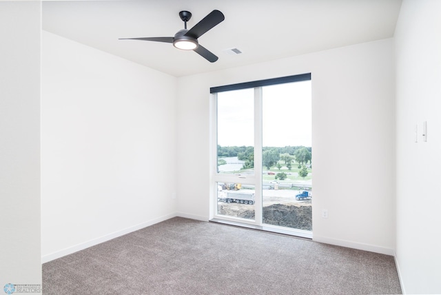 carpeted empty room featuring a wealth of natural light and ceiling fan