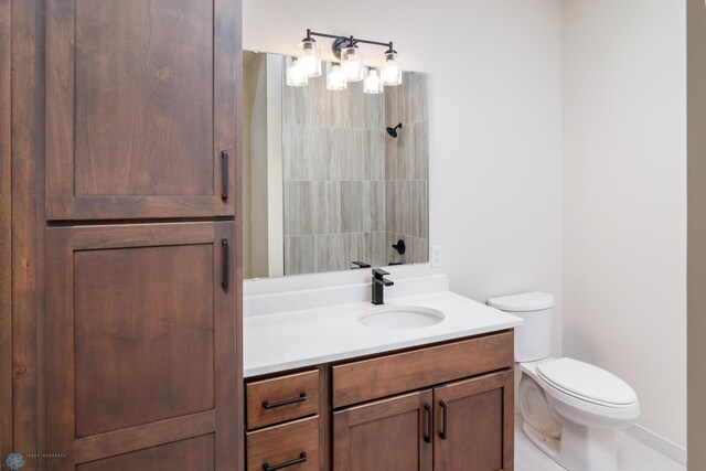 bathroom with tile patterned floors, vanity, and toilet