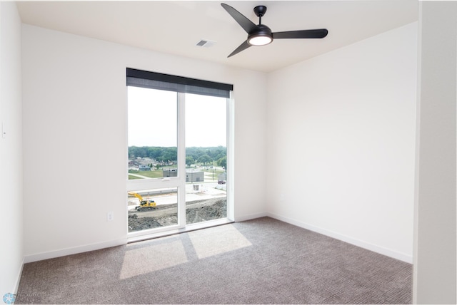 unfurnished room with ceiling fan and carpet