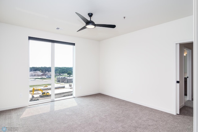 carpeted spare room with ceiling fan