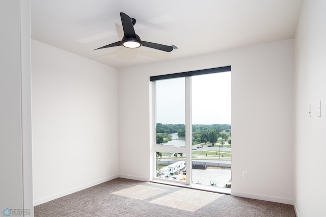 carpeted spare room with plenty of natural light and ceiling fan