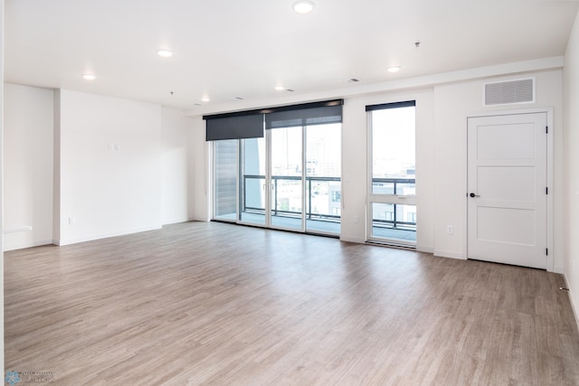 empty room with light hardwood / wood-style flooring