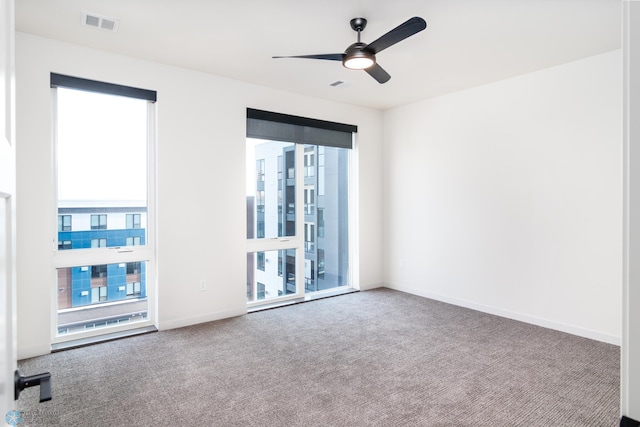 carpeted empty room featuring ceiling fan