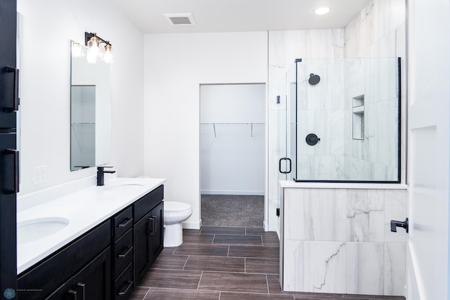 bathroom featuring vanity, toilet, and walk in shower