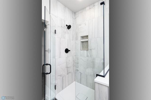 bathroom with a shower with shower door