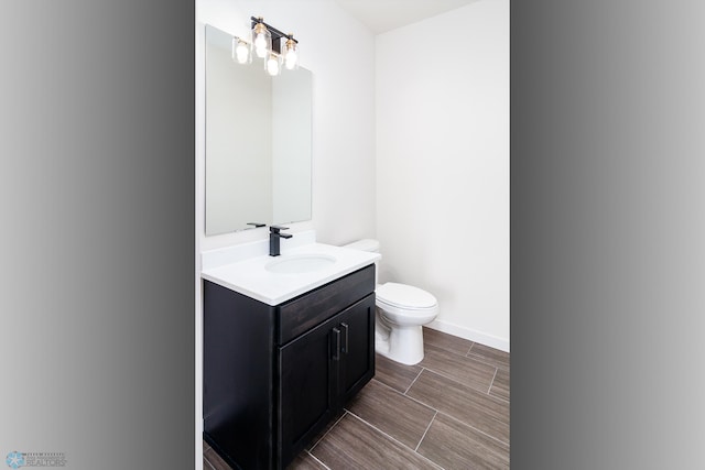 bathroom featuring toilet and vanity