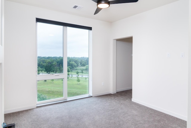 carpeted empty room featuring ceiling fan