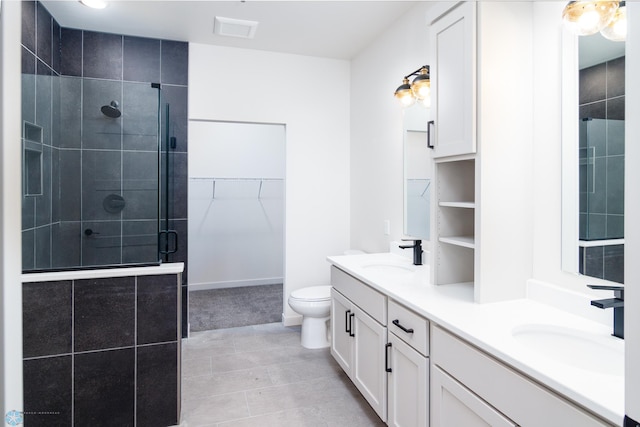 bathroom with tile patterned flooring, vanity, toilet, and an enclosed shower