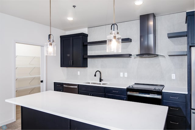 kitchen featuring a center island, light wood-type flooring, stainless steel appliances, sink, and wall chimney range hood