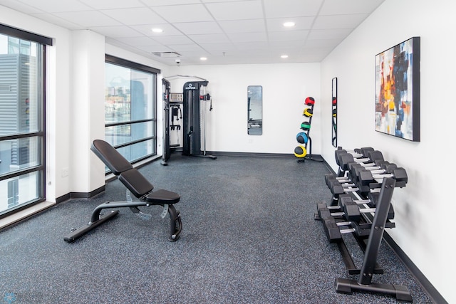 workout area with recessed lighting, baseboards, visible vents, and a paneled ceiling