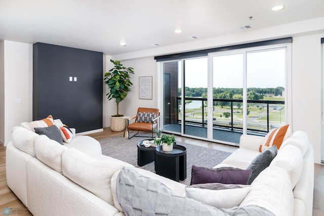 living room with visible vents, wood finished floors, and recessed lighting