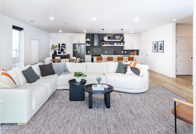 living room featuring light wood-style flooring and recessed lighting
