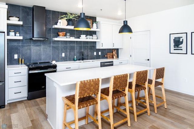 kitchen featuring a sink, range with electric cooktop, wall chimney range hood, and open shelves