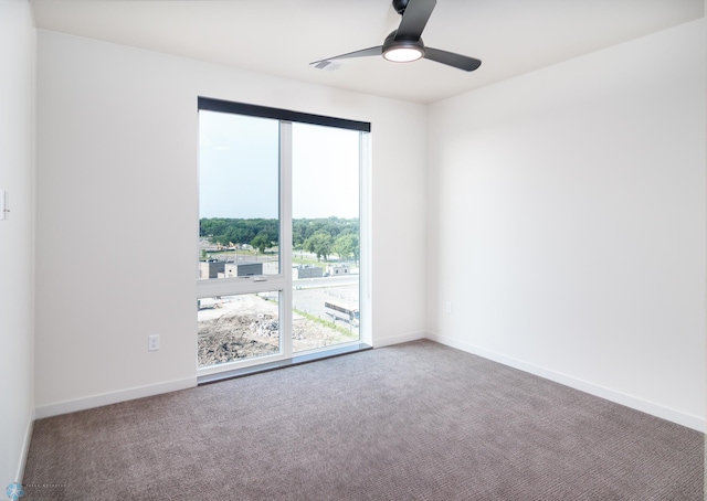 spare room with baseboards, carpet floors, and a ceiling fan