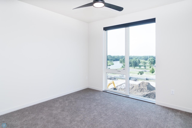 unfurnished room featuring ceiling fan and carpet