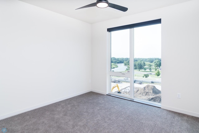 empty room featuring baseboards, ceiling fan, and carpet floors