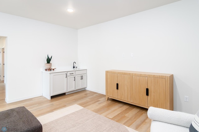 interior space with sink and light hardwood / wood-style floors