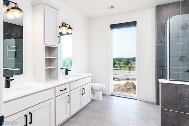 bathroom featuring vanity, toilet, tile patterned floors, and walk in shower