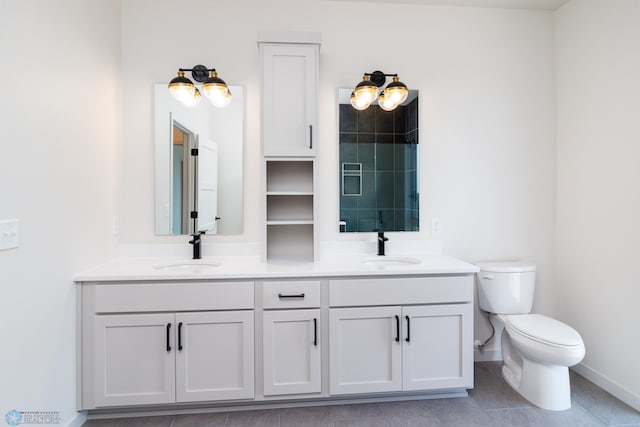 bathroom featuring vanity, toilet, and tile patterned floors