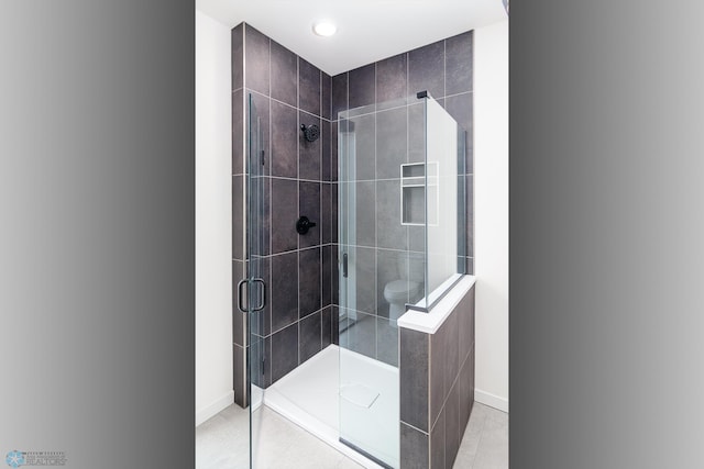 bathroom with tile patterned flooring and walk in shower