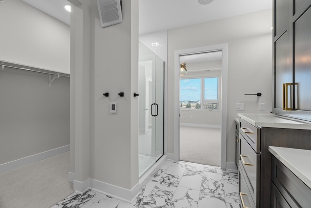 bathroom featuring vanity and a shower with shower door