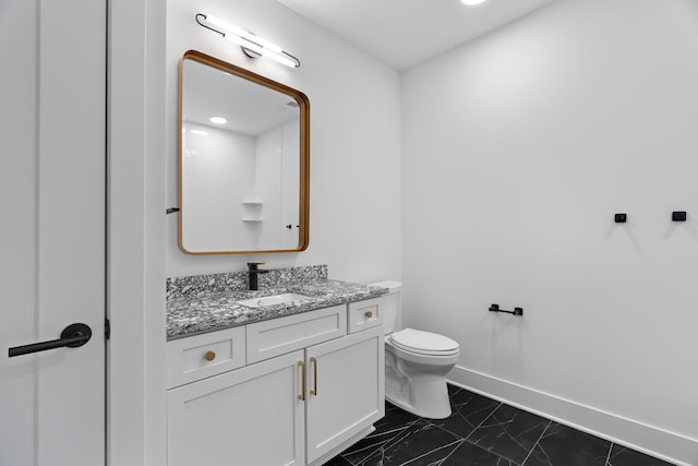 bathroom featuring vanity and toilet