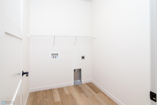 clothes washing area featuring hookup for a washing machine, electric dryer hookup, and light wood-type flooring