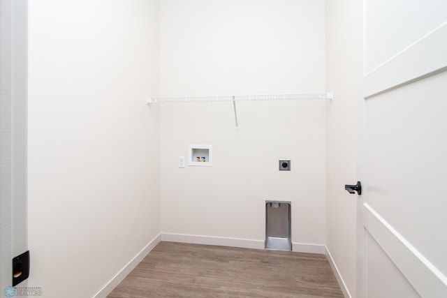 clothes washing area with washer hookup, hookup for an electric dryer, and light hardwood / wood-style floors