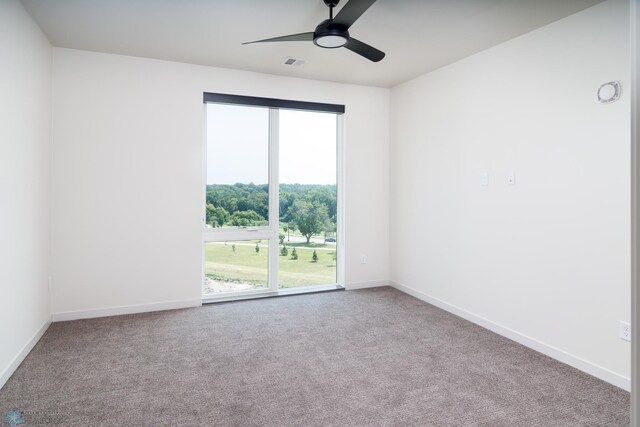 empty room featuring light colored carpet and ceiling fan