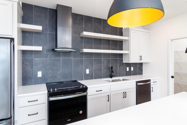 kitchen with appliances with stainless steel finishes, backsplash, sink, wall chimney range hood, and white cabinets