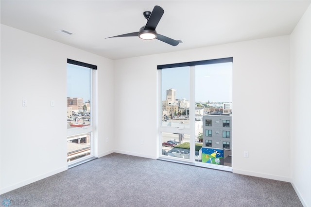 carpeted empty room featuring ceiling fan