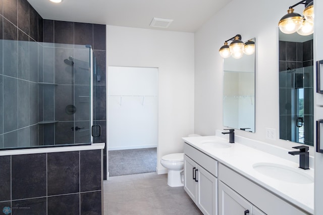 bathroom featuring tile patterned flooring, vanity, an enclosed shower, and toilet