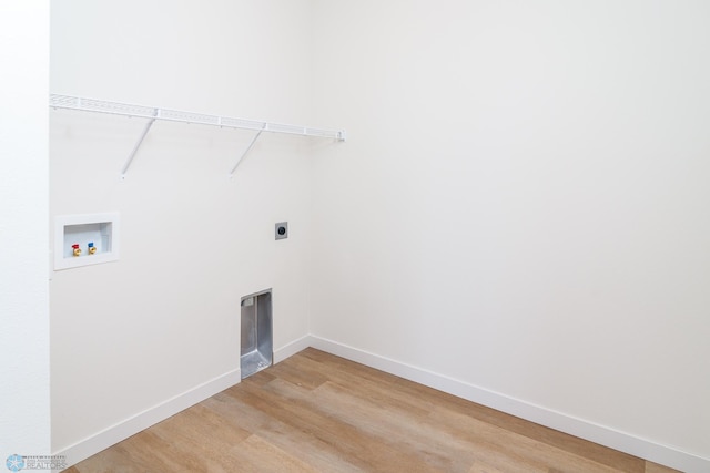 clothes washing area featuring hardwood / wood-style flooring, electric dryer hookup, and washer hookup