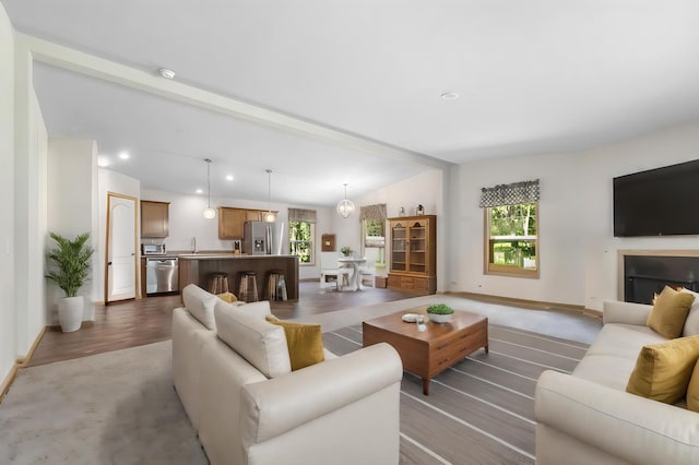 living room with vaulted ceiling and light hardwood / wood-style flooring